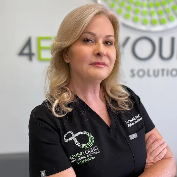 Professional portrait of Lori in black 4Ever Young Wellington scrubs.
