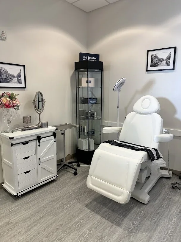 Empty room with white reclining chair, magnifier, cabinet and product-display case.