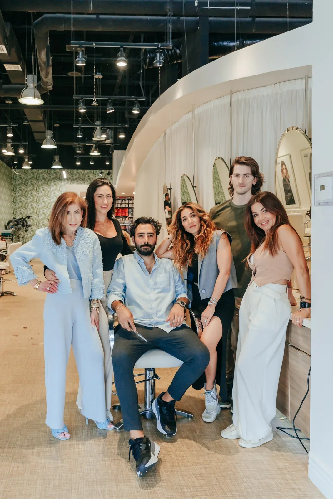 Group portrait of Anushka Spa & Salon employees inside the hair salon