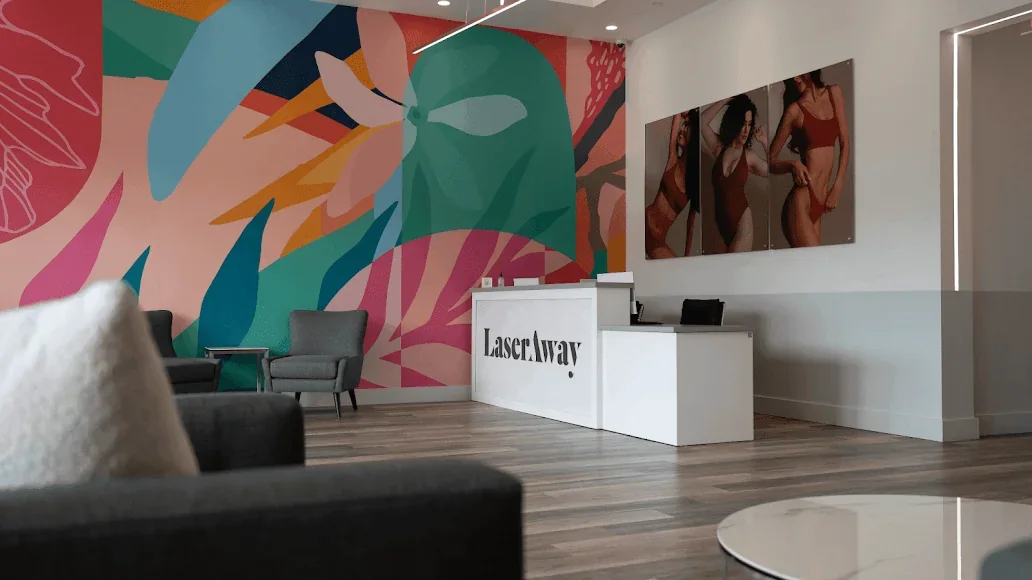 LaserAway Pembroke Pines reception desk beside a colorful mural.