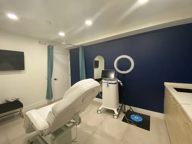 BeWell MedSpa empty treatment room with navy accent wall.