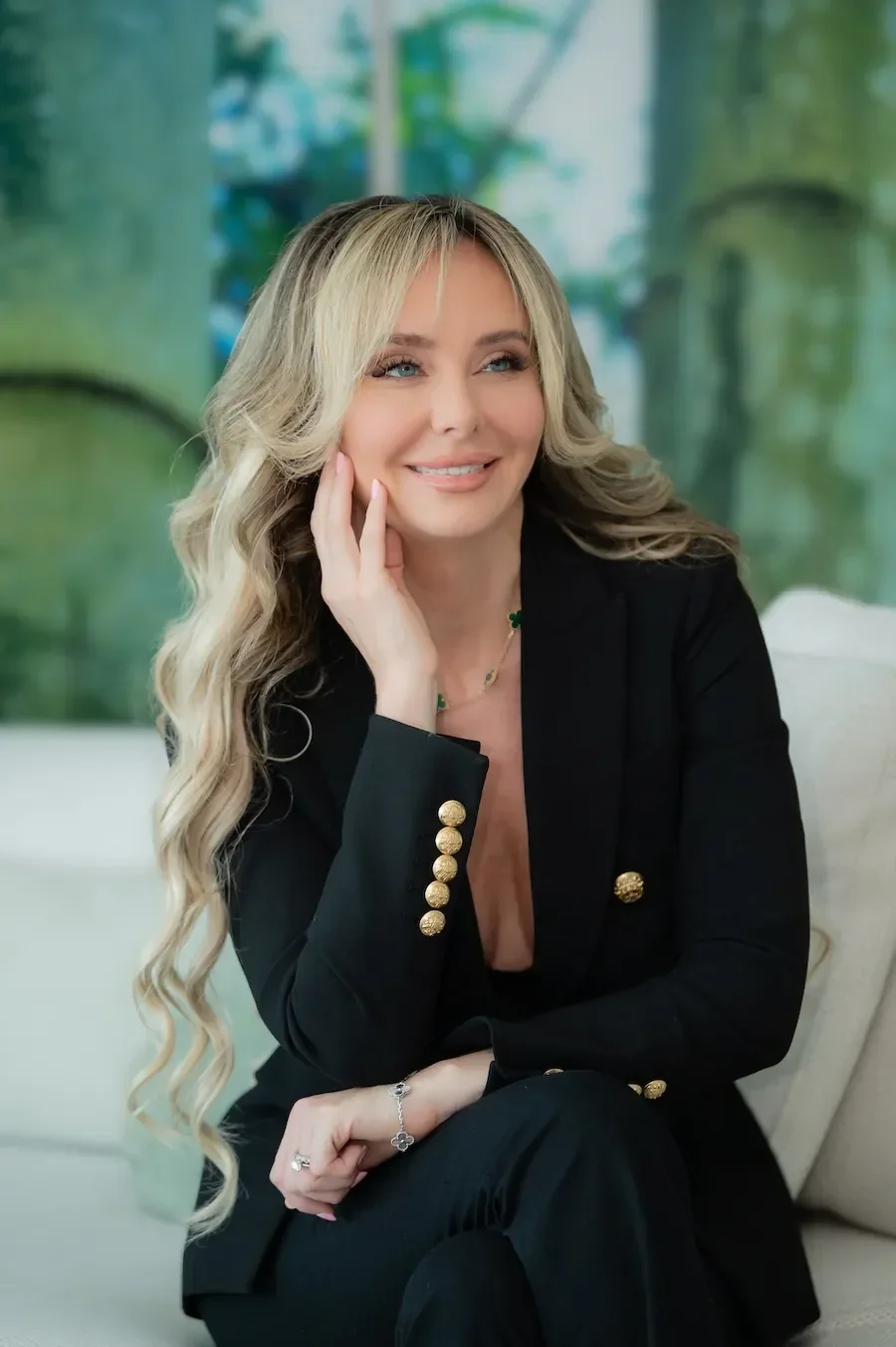 Maria Norris seated in a black jacket with gold buttons.