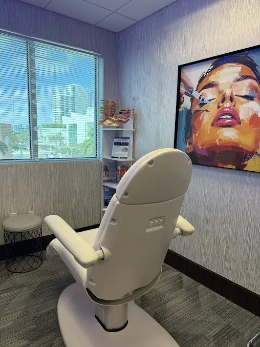 Empty reclining chair beside a window, small shelf and colorful facial illustration.