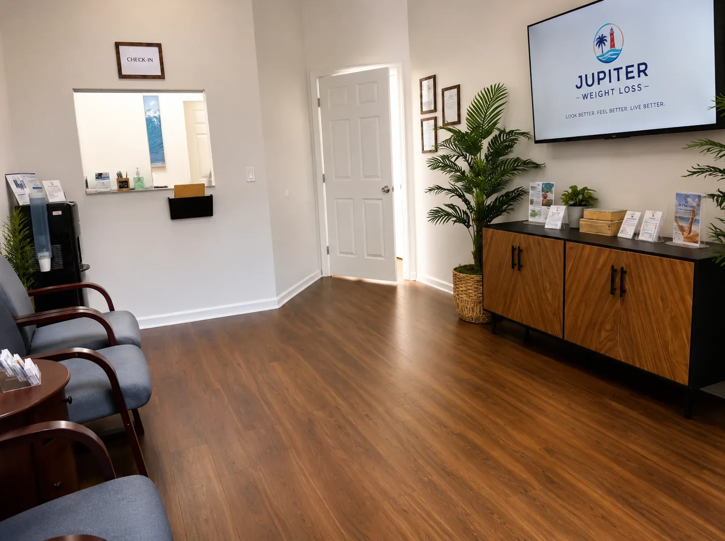 A check-in window and wood cabinet in the empty Jupiter Weight Loss reception area.