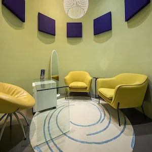 Empty consultation room with yellow seating at MD Beauty Labs.