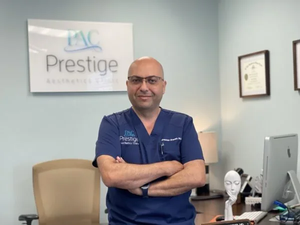 Professional portrait of Dr. Giacomo Strada in blue branded scrubs.