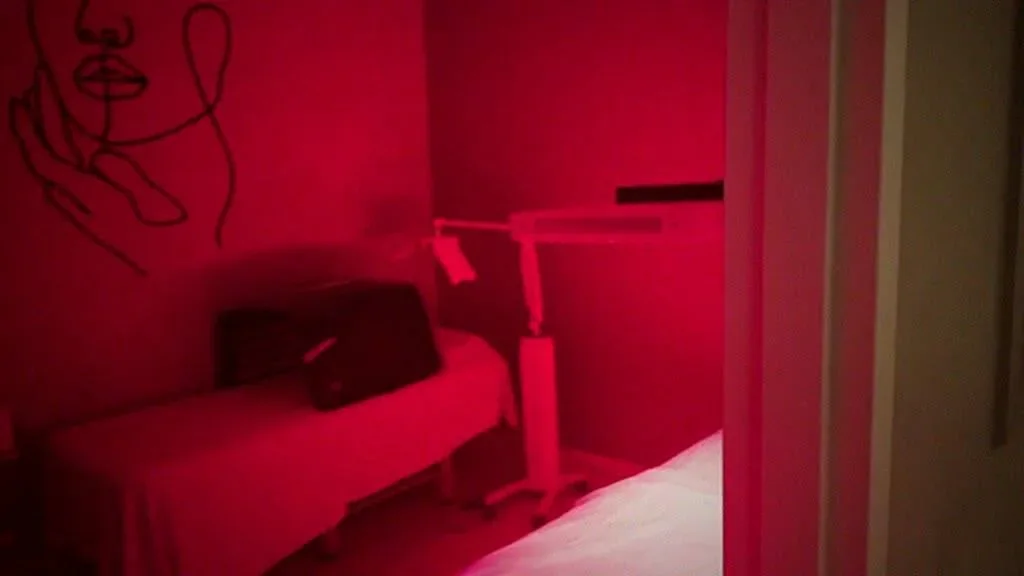 NewYou Medical Spa room under red lighting.