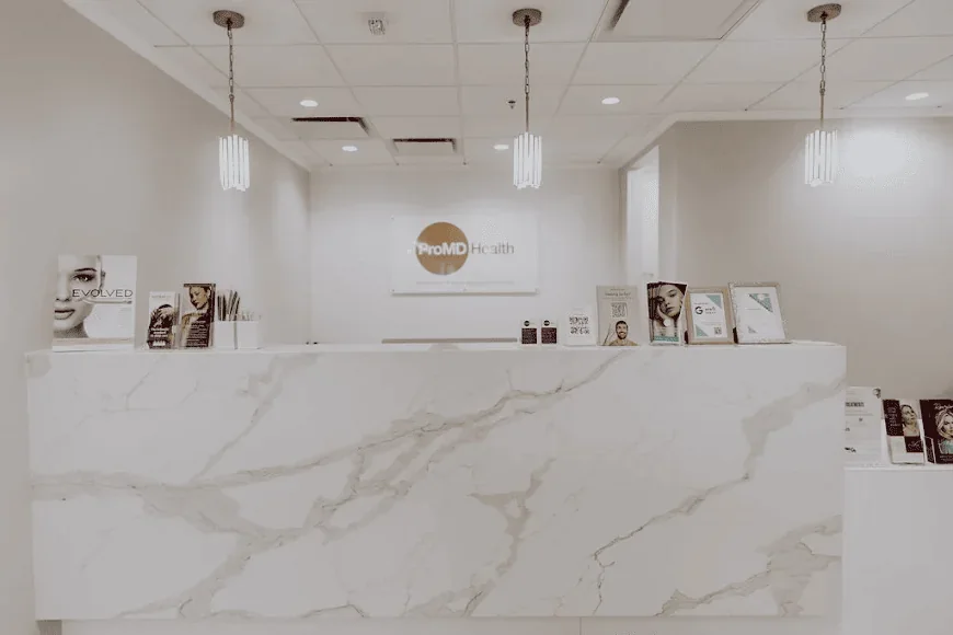 The empty branded reception desk shown in ProMD Health Fort Lauderdale's gallery.
