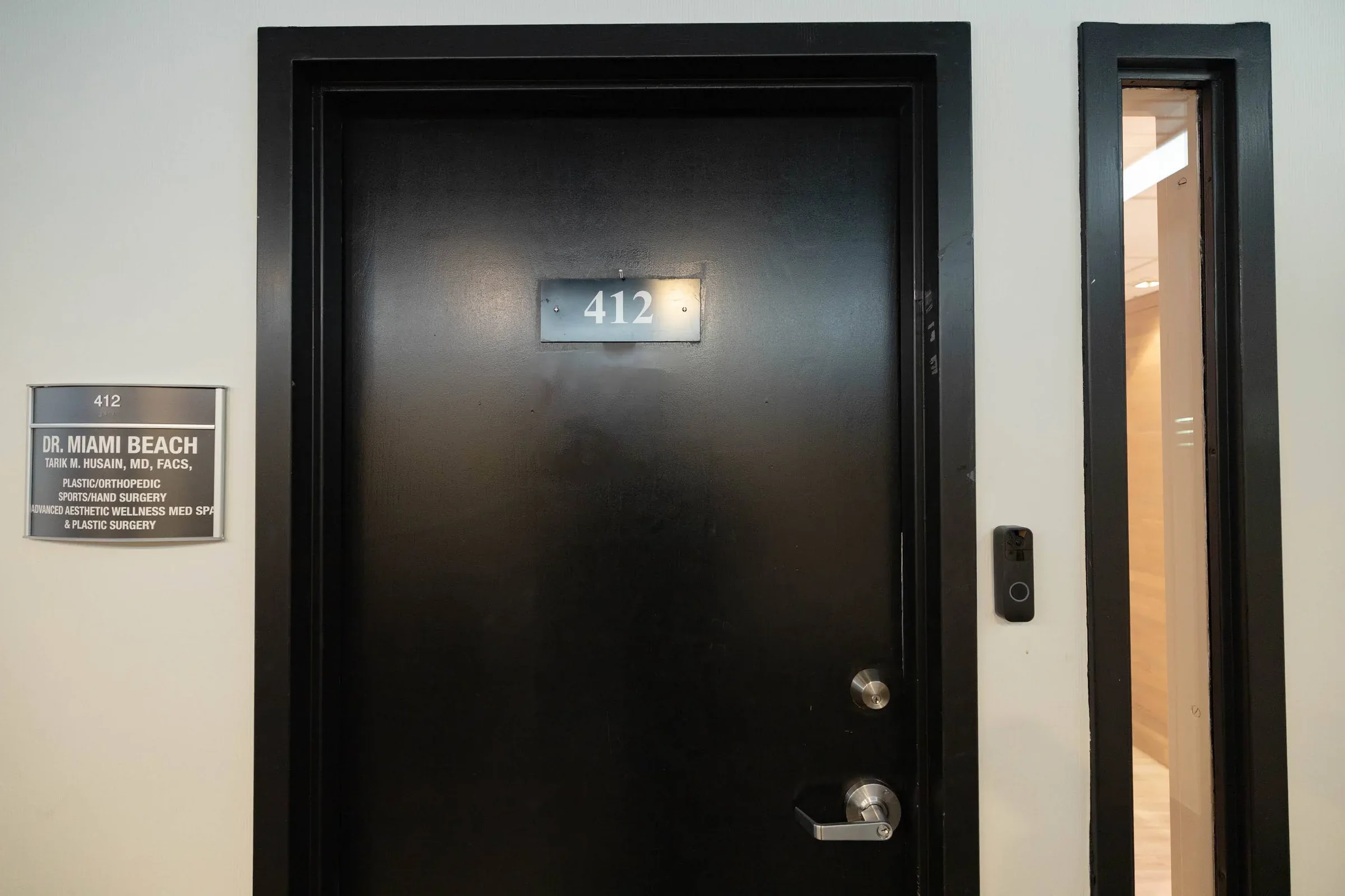 Black suite door marked 412 beside a Dr. Miami Beach nameplate.