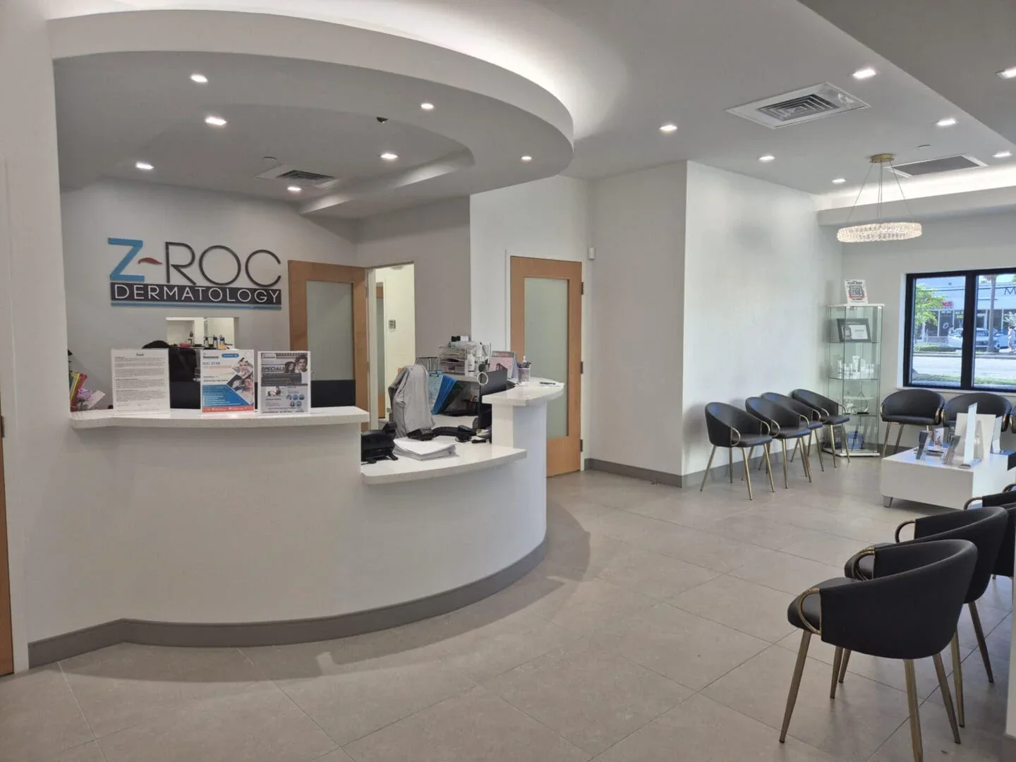 Curved reception counter with Z-ROC wall signage and rows of dark waiting chairs.