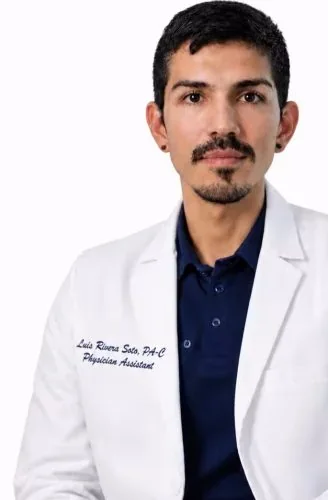 Luis Rivera Soto in a white physician-assistant coat against a plain background.