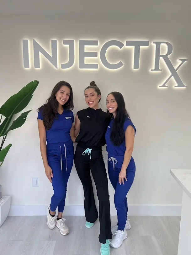 InjectRX Wellness Mizner Park team beneath the clinic sign.