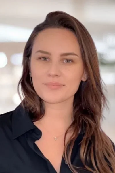 Maria Subacheva in a black collared shirt.