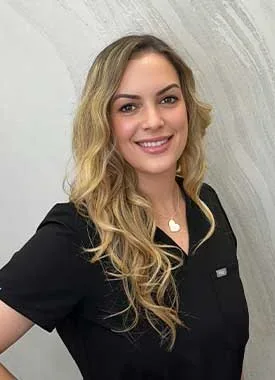 Stephanie Casares wearing black scrubs against a neutral background.