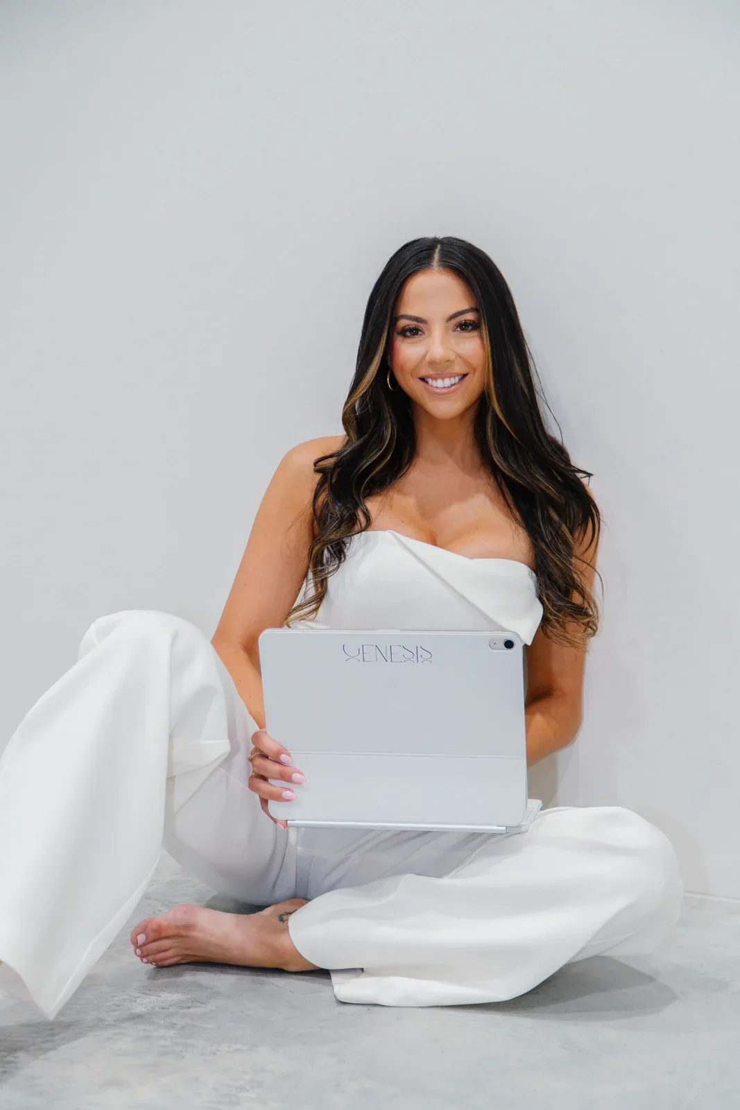 Genesis Wellness & Aesthetics team member presenting a wellness product