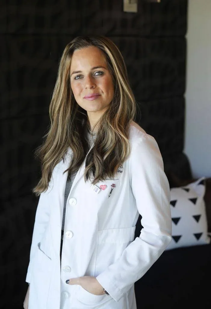 Lisa Lifshitz in a white coat in a professional portrait.